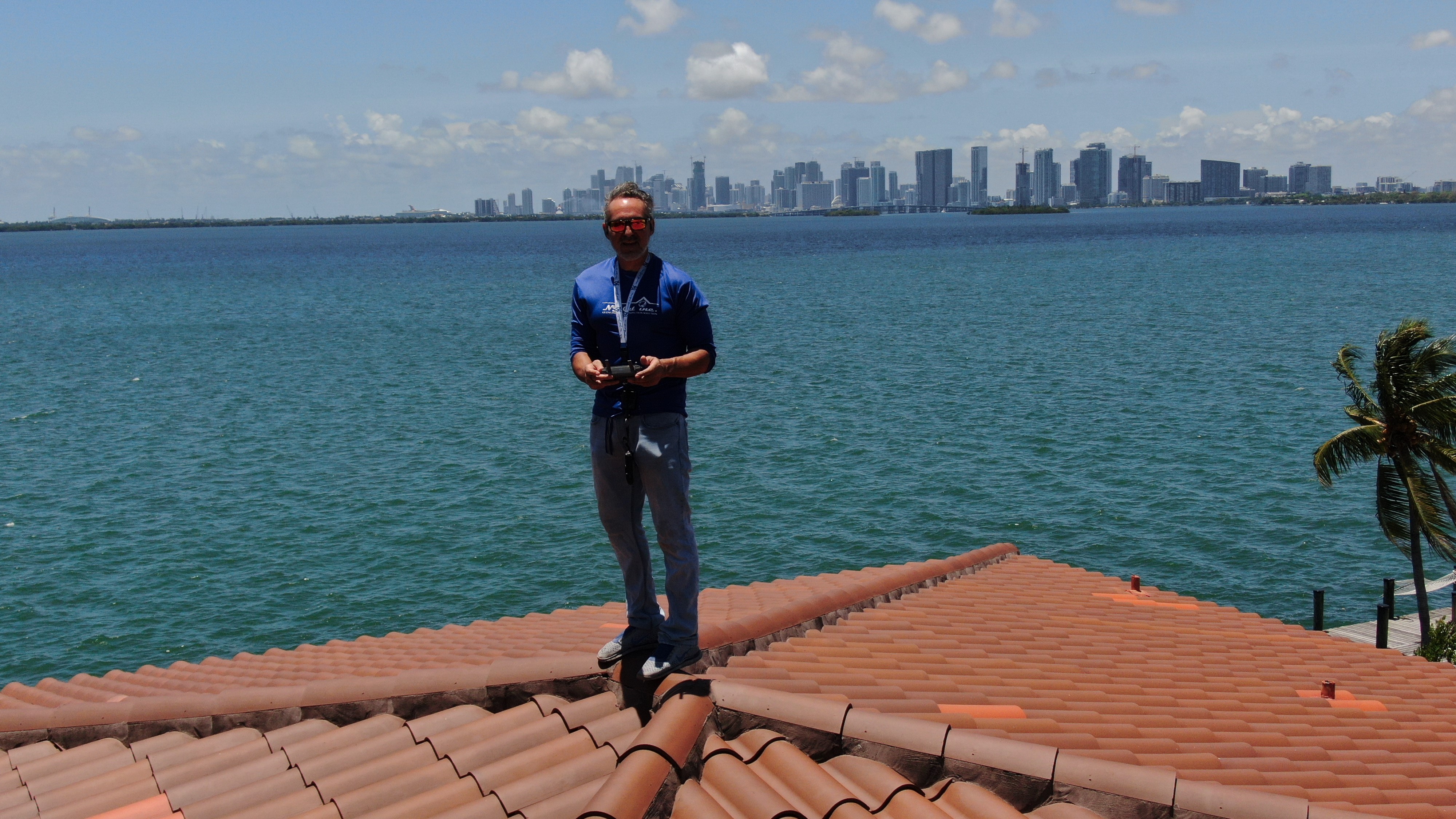Nicholas J. Catalano using drone equipment on a coastal roof
